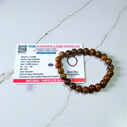 Image of a natural Tiger Eye bracelet made of 8mm golden-brown beads with a silky shine, arranged in a circular shape on a neutral background