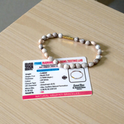 Image of two adjustable spiritual bracelets – one made with white Vaijanti seeds and the other with brown Kamal Gutta beads – displayed on a natural surface
