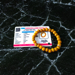 Image of two stretchable bracelets – one made with white Vaijanti seeds and one with yellow Haldi beads – arranged side by side on a natural background