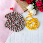 Image showing a combo of Kamal Gutta Mala and Haldi Mala with 108+1 beads, handcrafted and lab certified, placed on a spiritual cloth background