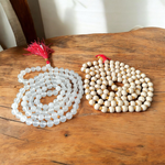 Image showing a combo of Tulsi Mala and Sphatik Mala with traditional guru beads, neatly arranged on a spiritual cloth background