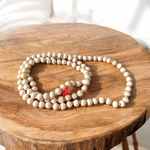 Image showing a combo of Tulsi Mala and Sphatik Mala with traditional guru beads, neatly arranged on a spiritual cloth background