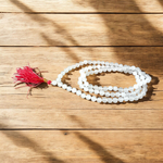 Image showing a combo of Tulsi Mala and Sphatik Mala with traditional guru beads, neatly arranged on a spiritual cloth background