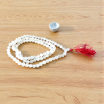 Image showing a combo of Tulsi Mala and Sphatik Mala with traditional guru beads, neatly arranged on a spiritual cloth background