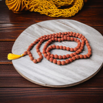 Image showing a complete set of 5 Mukhi Rudraksha Mala and a matching Rudraksha Pendant with metal capping on a spiritual background