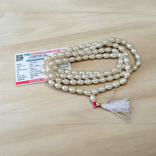 Image showing a hand-knotted Moti Mala made of smooth, white natural pearls with a central guru bead, placed on a sacred cloth for worship
