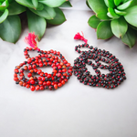 Image showing combo of Lal Gunja Mala and Black Gunja Mala with 108+1 beads, lab certified, placed aesthetically on a spiritual cloth for rituals or meditation