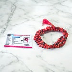 Image showing combo of Lal Gunja Mala and Black Gunja Mala with 108+1 beads, lab certified, placed aesthetically on a spiritual cloth for rituals or meditation