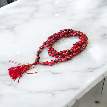 Image showing combo of Lal Gunja Mala and Black Gunja Mala with 108+1 beads, lab certified, placed aesthetically on a spiritual cloth for rituals or meditation