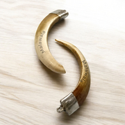 Lab-certified Shukar Dant (Wild Boar Tooth) pendants in silver caps, available in C-shape, U-shape, and baby sizes for protection and business success