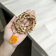 Lab-certified small bead Tulsi Kanthi Mala with double strands, displayed on a traditional wooden background