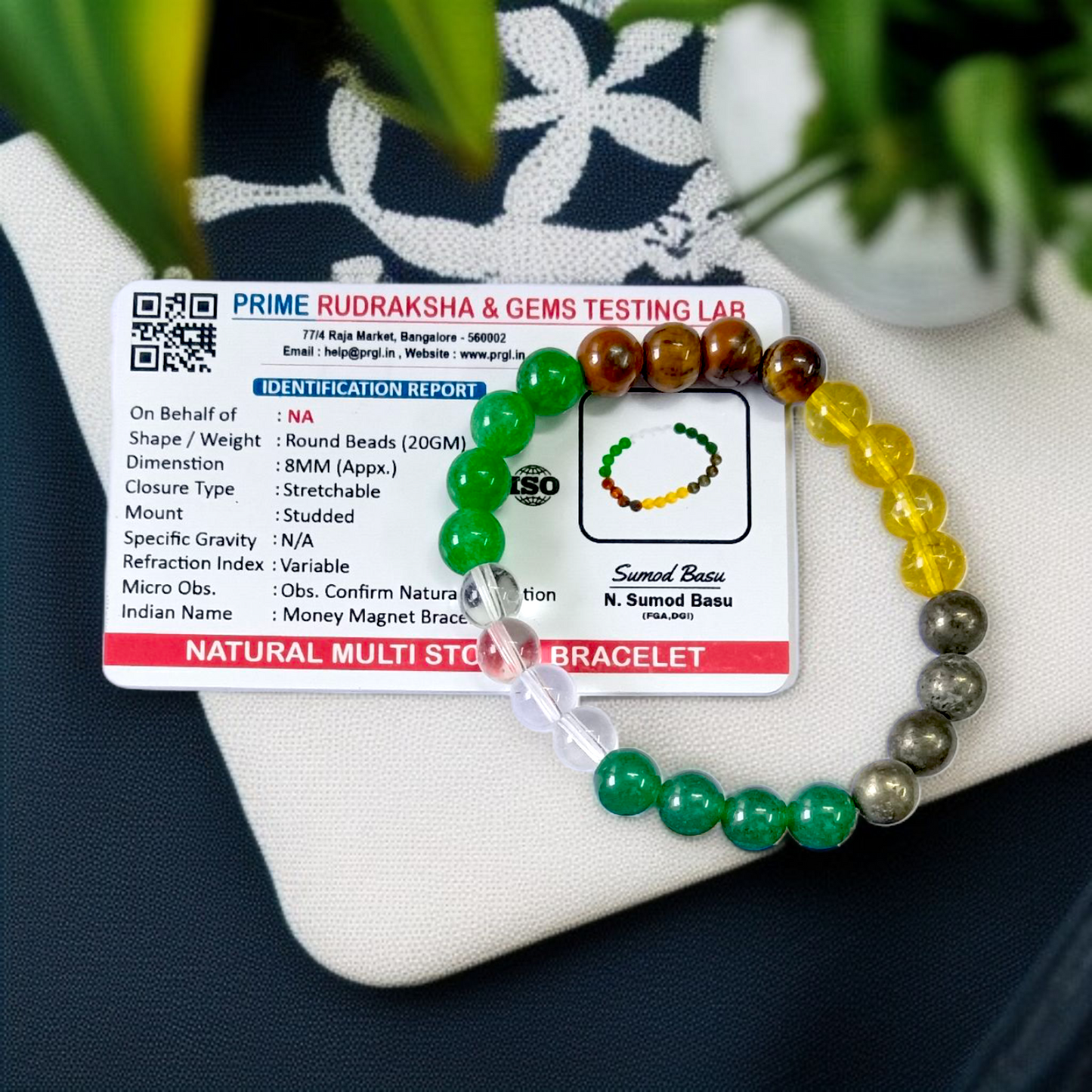 Lab certified Money Magnet Bracelet made with polished 8mm Green Aventurine, Citrine, and Pyrite beads, stretchable design placed on a soft fabric background