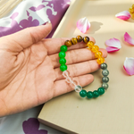 Lab certified Money Magnet Bracelet made with polished 8mm Green Aventurine, Citrine, and Pyrite beads, stretchable design placed on a soft fabric background