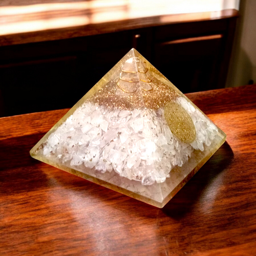 Lab certified orgone pyramid featuring white healing stones, a copper coil, and clear resin body designed for energy balancing and meditation