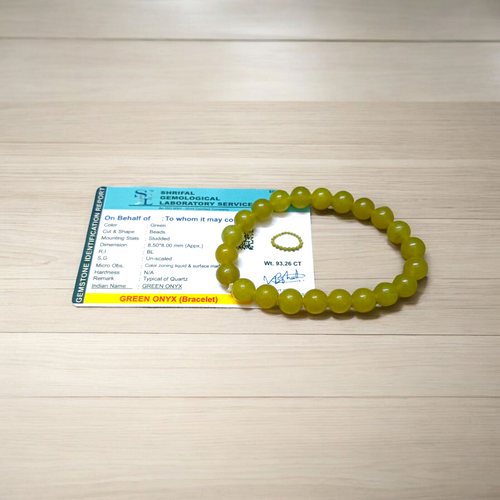 Light green onyx bracelet with 8mm round beads, stretchable elastic design, displayed on a wooden surface