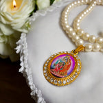 Moti mala with white pearls and Radha Krishna locket placed on a velvet cloth background