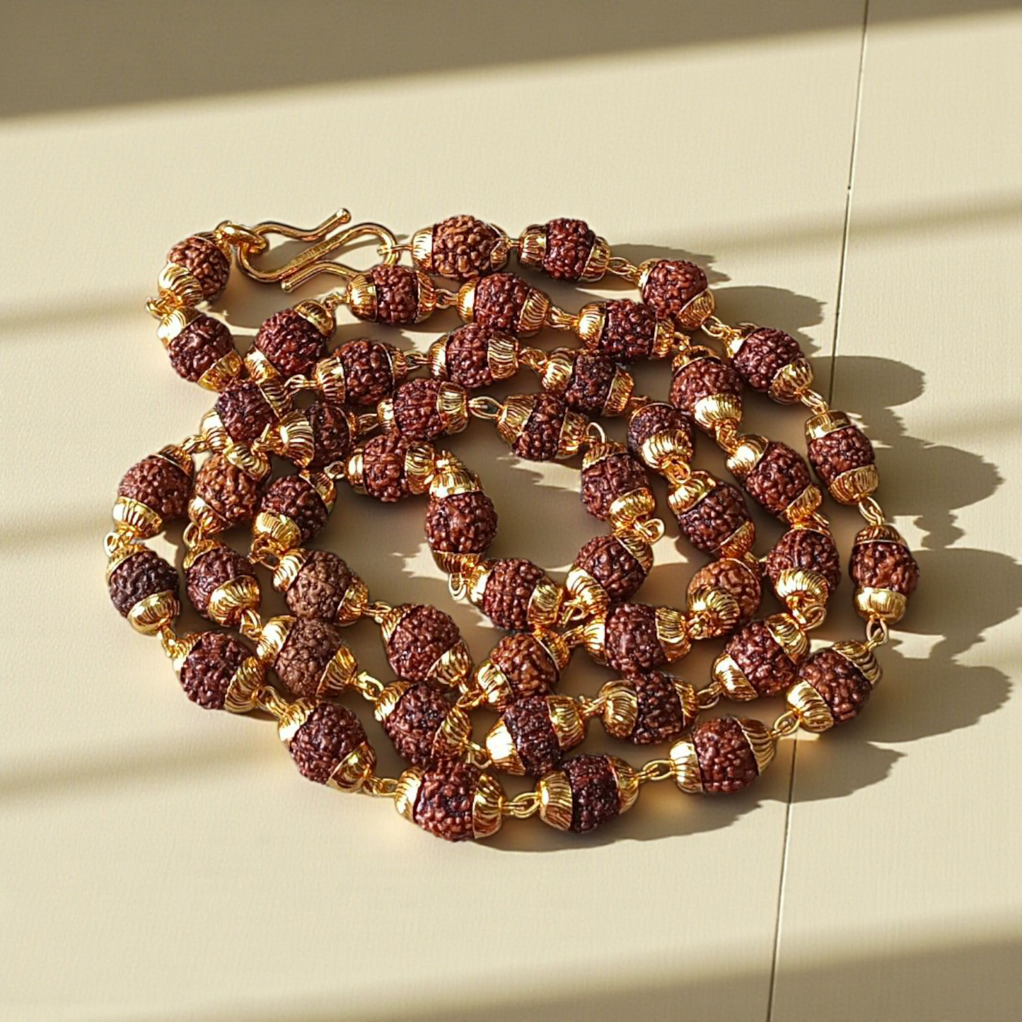 Natural 5 Face Rudraksha Mala with 50 golden-capped 6mm beads, handcrafted and lab-certified, ideal for meditation and daily wear with 1-year plating guarantee
