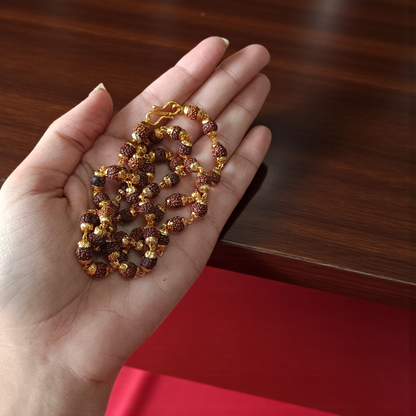 Natural 5 Face Rudraksha Mala with 50 golden-capped 6mm beads, handcrafted and lab-certified, ideal for meditation and daily wear with 1-year plating guarantee