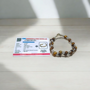 Natural Blue Chalcedony Bracelet made with 8mm smooth round stretchable beads, lab certified, placed on a natural stone background