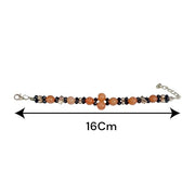 Natural Hessonite Bracelet with polished round beads on elastic cord, lab certified, placed on a wooden surface
