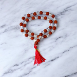 Natural Rudraksha and Sphatik crystal mala with 54+1 hand-strung 7-8mm beads, alternating design, placed on a plain background