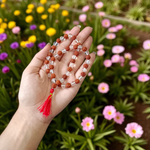 Natural Rudraksha and Sphatik crystal mala with 54+1 hand-strung 7-8mm beads, alternating design, placed on a plain background