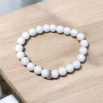 Natural White Agate Bracelet with 8mm polished round beads on stretchable thread, displayed on a white background