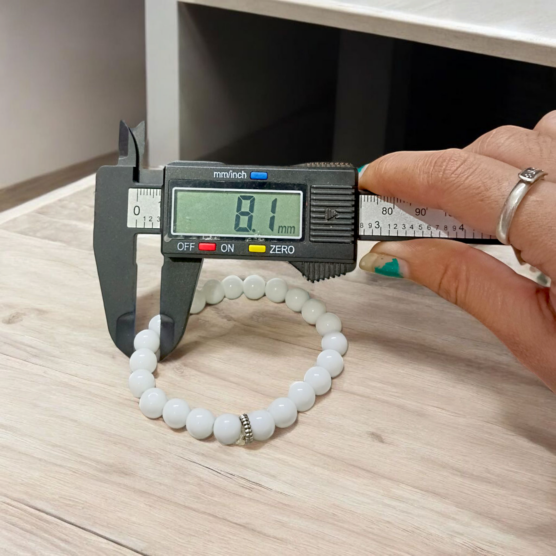 Natural White Agate Bracelet with 8mm polished round beads on stretchable thread, displayed on a white background