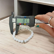 Natural White Agate Bracelet with 8mm polished round beads on stretchable thread, displayed on a white background
