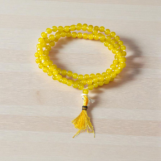 Natural Yellow Agate (Hakik) mala with 108+1 polished 6mm gemstone beads, hand-knotted with a guru bead, displayed on a neutral background 