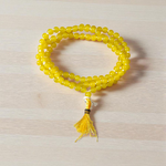 Natural Yellow Agate (Hakik) mala with 108+1 polished 6mm gemstone beads, hand-knotted with a guru bead, displayed on a neutral background 