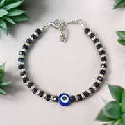 Nazariya anklet for kids with black beads and silver-toned accents, designed for spiritual protection, luck, and daily comfort