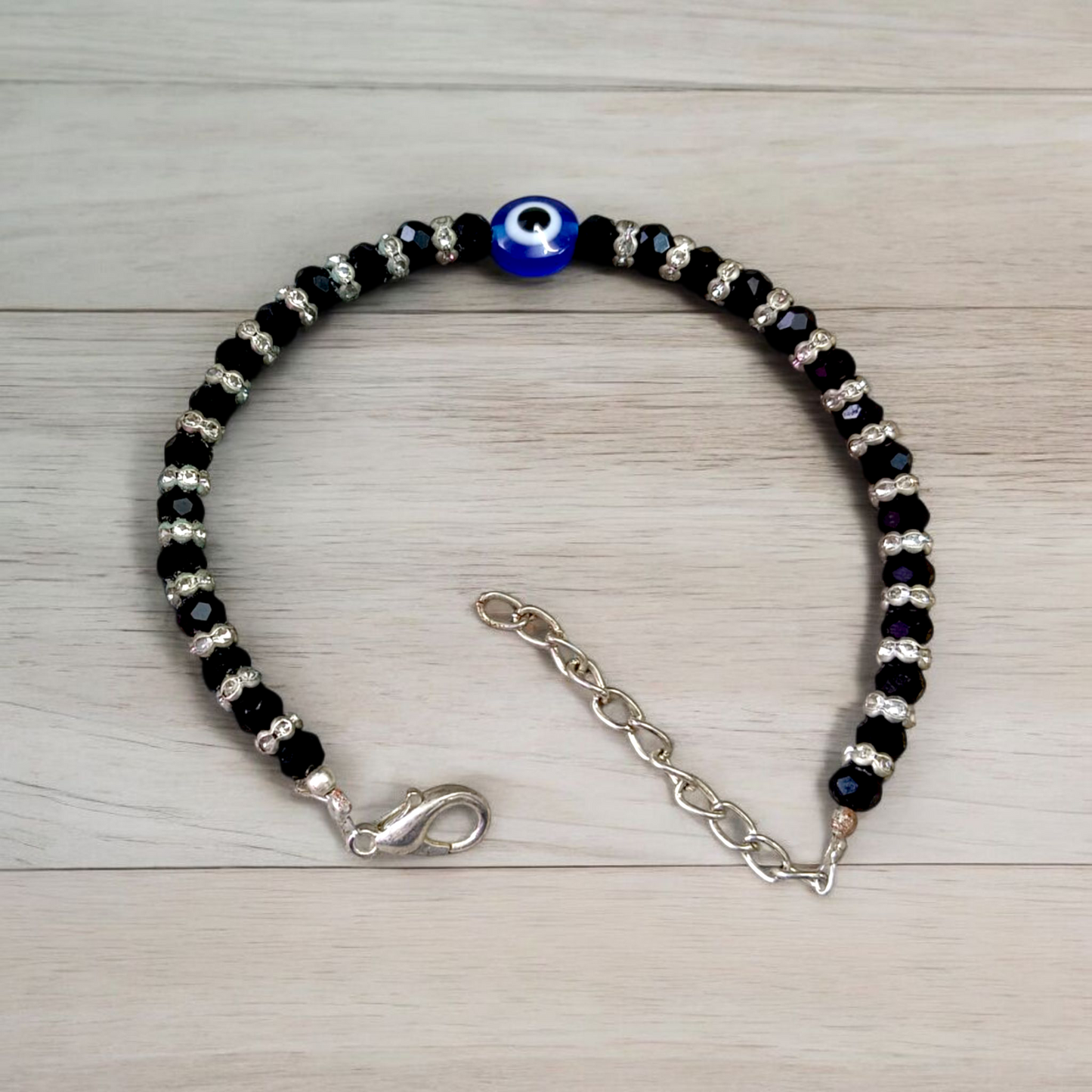 Nazariya anklet for kids with black beads and silver-toned accents, designed for spiritual protection, luck, and daily comfort