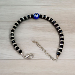 Nazariya anklet for kids with black beads and silver-toned accents, designed for spiritual protection, luck, and daily comfort
