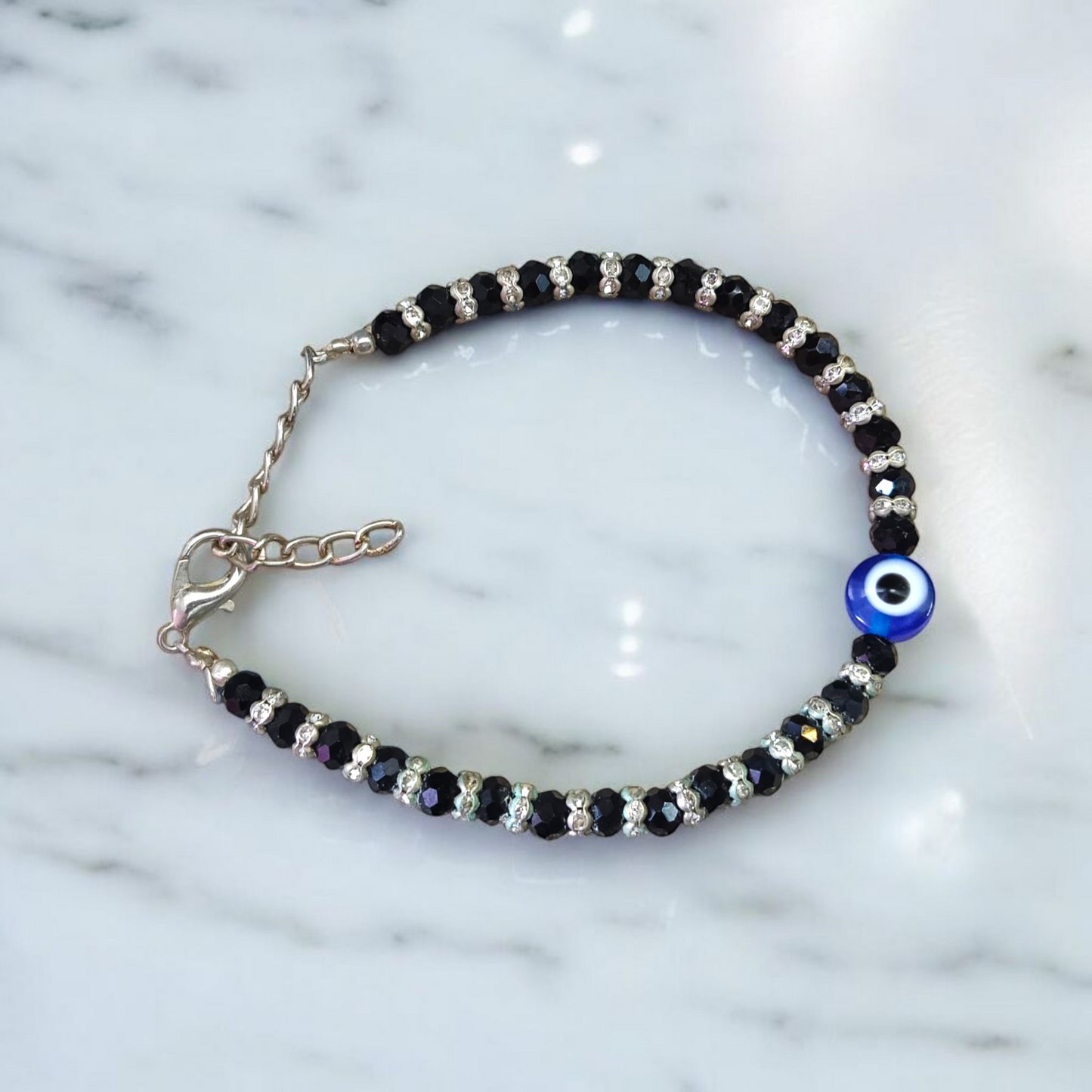 Nazariya anklet for kids with black beads and silver-toned accents, designed for spiritual protection, luck, and daily comfort