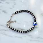 Nazariya anklet for kids with black beads and silver-toned accents, designed for spiritual protection, luck, and daily comfort
