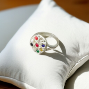 Oval-shaped gold-plated Navratan ring with nine colorful gemstones set in a tortoise design for spiritual and astrological benefits