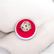 Oval-shaped gold-plated Navratan ring with nine colorful gemstones set in a tortoise design for spiritual and astrological benefits