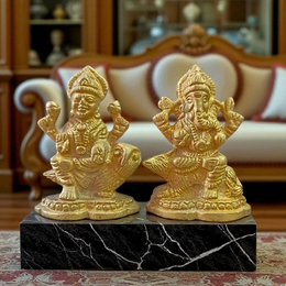 Pair of brass idols featuring Goddess Lakshmi and Lord Ganesha in intricate design, ideal for puja, gifting, and home decor