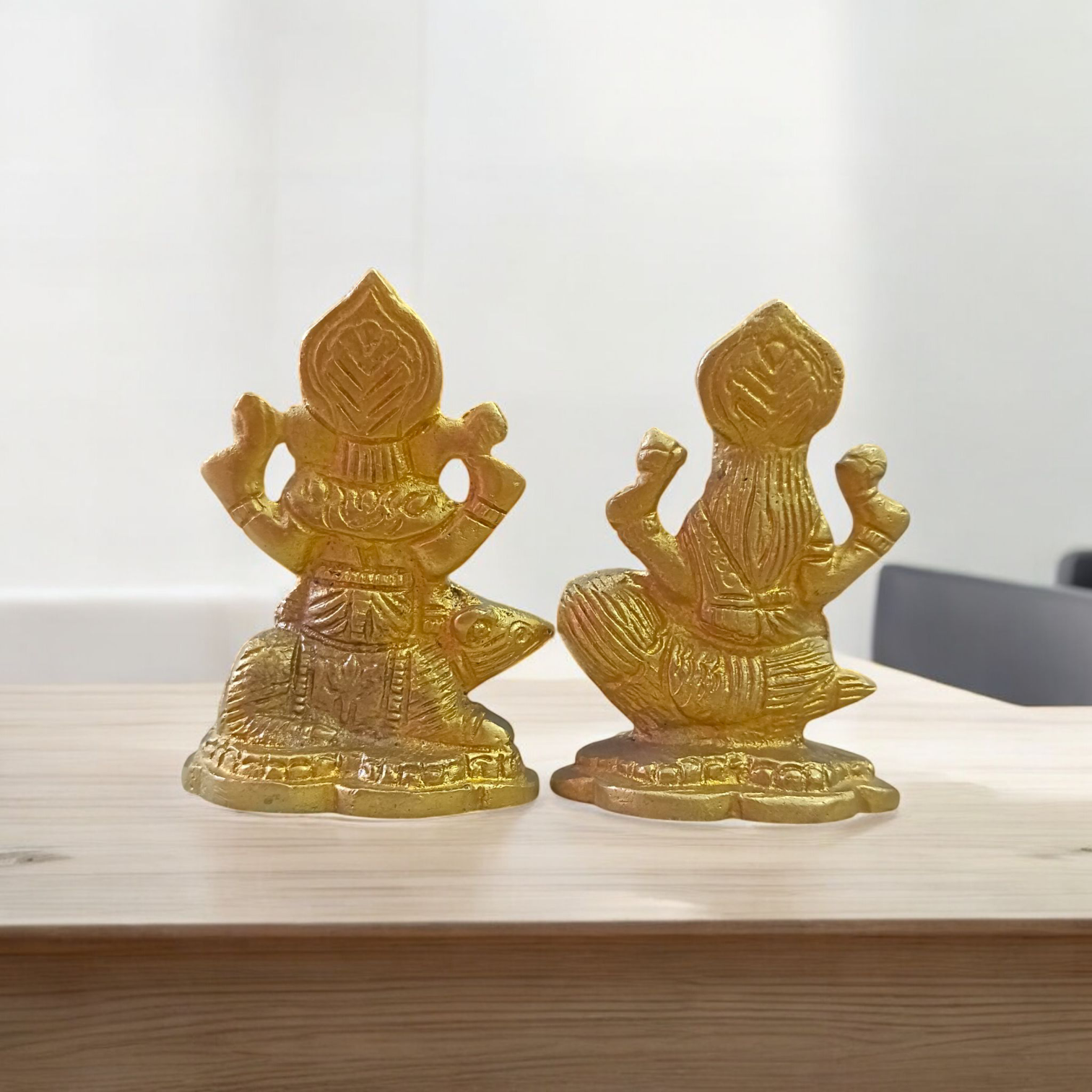 Pair of brass idols featuring Goddess Lakshmi and Lord Ganesha in intricate design, ideal for puja, gifting, and home decor