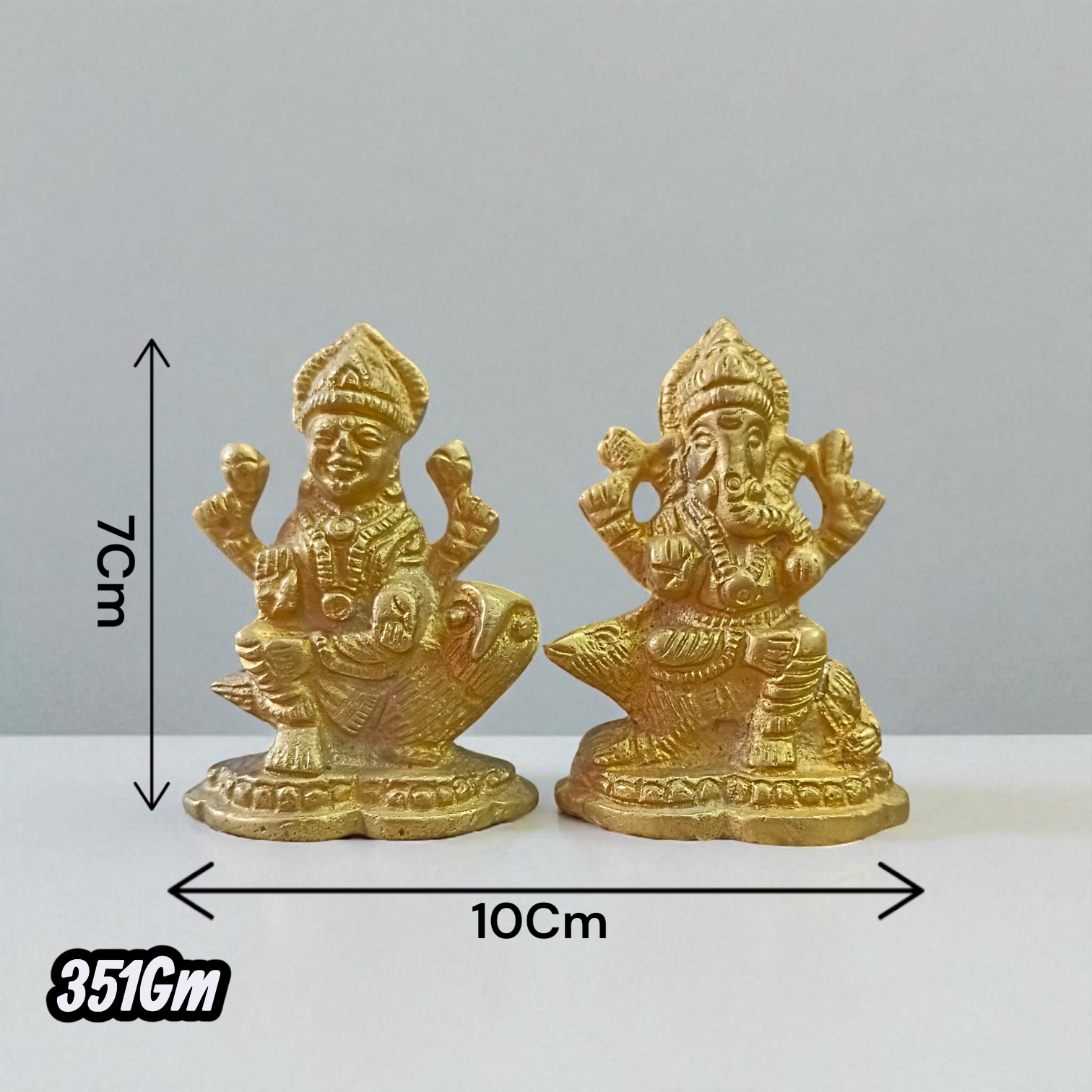Pair of brass idols featuring Goddess Lakshmi and Lord Ganesha in intricate design, ideal for puja, gifting, and home decor