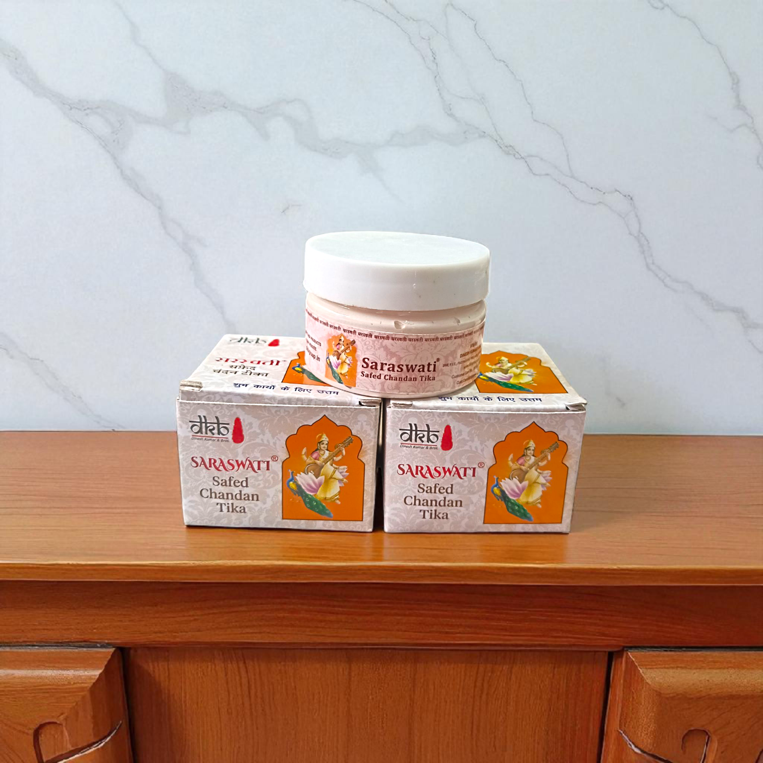 Pure white sandalwood paste (Safed Chandan Tilak) in a small container with creamy texture, ready for spiritual application