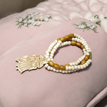 Radha Krishna Tulsi Chandan Mala featuring alternating Tulsi and sandalwood beads, engraved pendant, and screw-lock clasp, displayed neatly