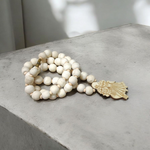 Radha Krishna Tulsi Mala with engraved pendant and screw lock, neatly arranged for devotional use on a soft background