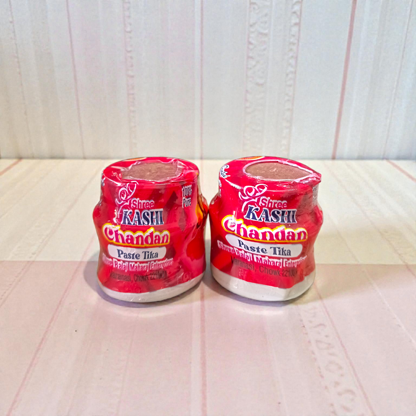 Red chandan paste container used for tilak, puja, and religious ceremonies
