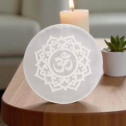 Selenite charging plate with engraved Om symbol, polished round design for pooja, décor, and crystal cleansing