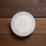 Selenite charging plate with engraved Om symbol, polished round design for pooja, décor, and crystal cleansing
