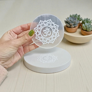 Selenite charging plate with engraved Om symbol, polished round design for pooja, décor, and crystal cleansing