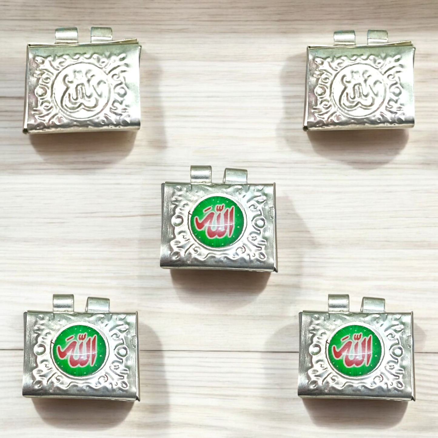 Set of 5 handcrafted silver square taweez with intricate Islamic design and free Bhojpatra sheet placed beside them