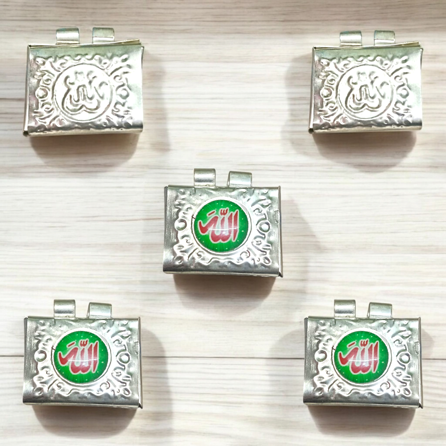 Set of 5 handcrafted silver square taweez with intricate Islamic design and free Bhojpatra sheet placed beside them